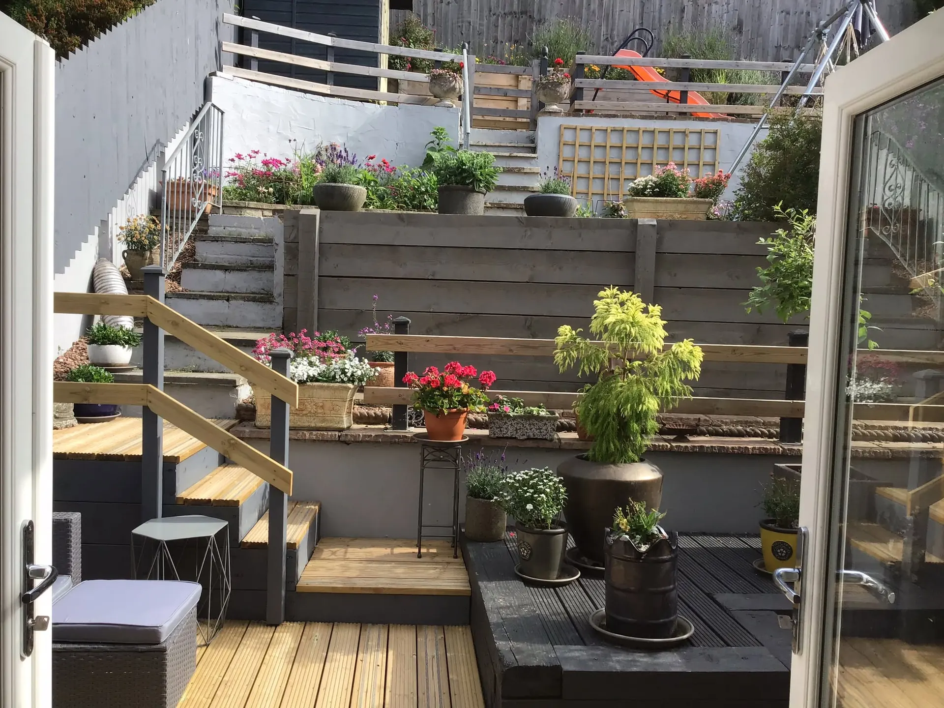 Multi-level timber decking built across a terraced garden in Newton Abbot