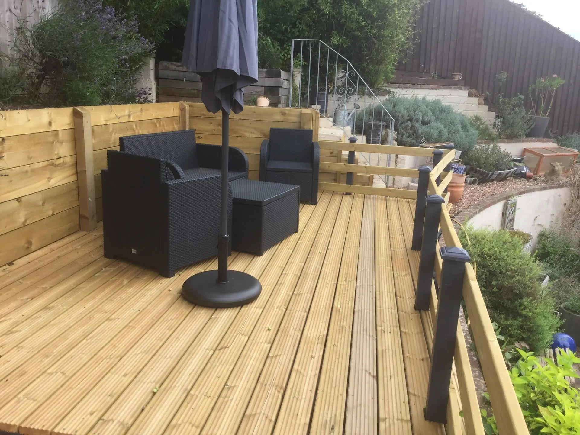 Raised timber decking with a privacy screen and balustrade